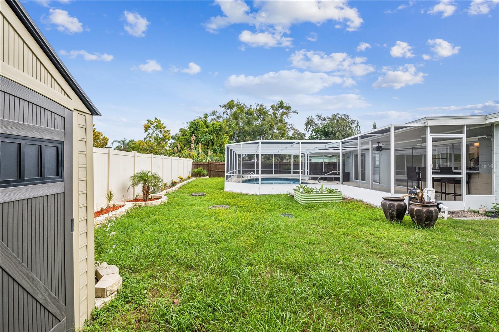 Large yard outside the pool area for the kida and pets