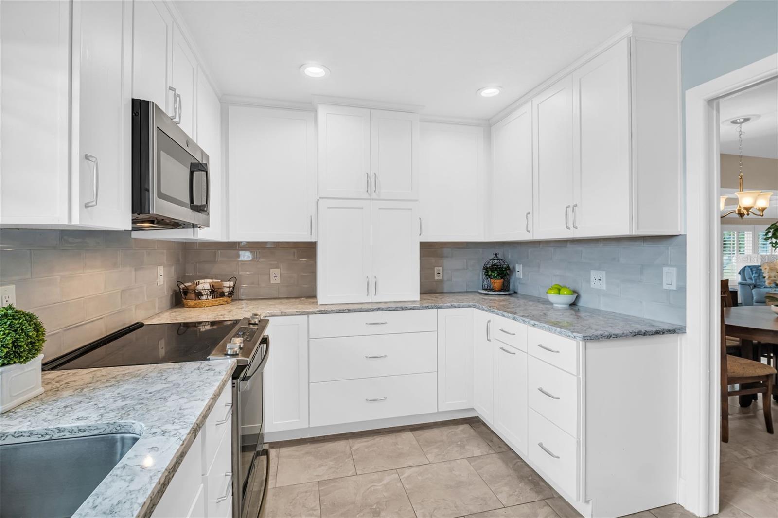 Professional kitchen remodel with wood cabinetry, Cambria Waterfall granite & pearl gray tile splash walls~