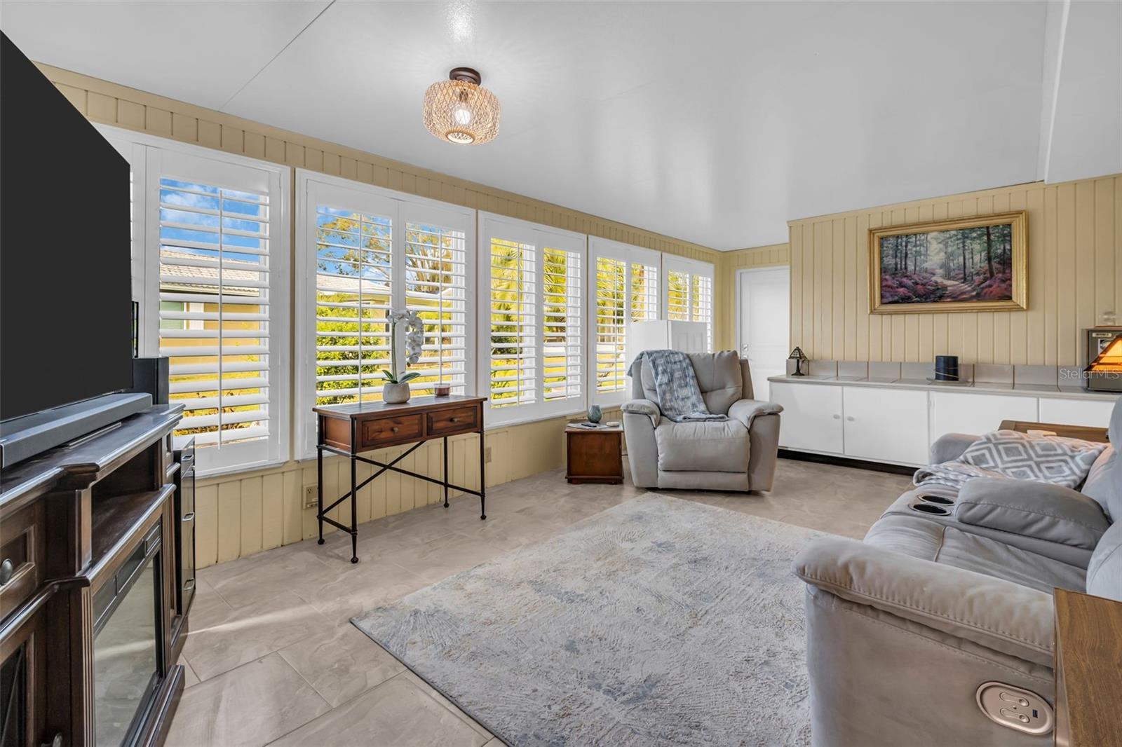 A versatile room features a window wall and storage room behind credenza~