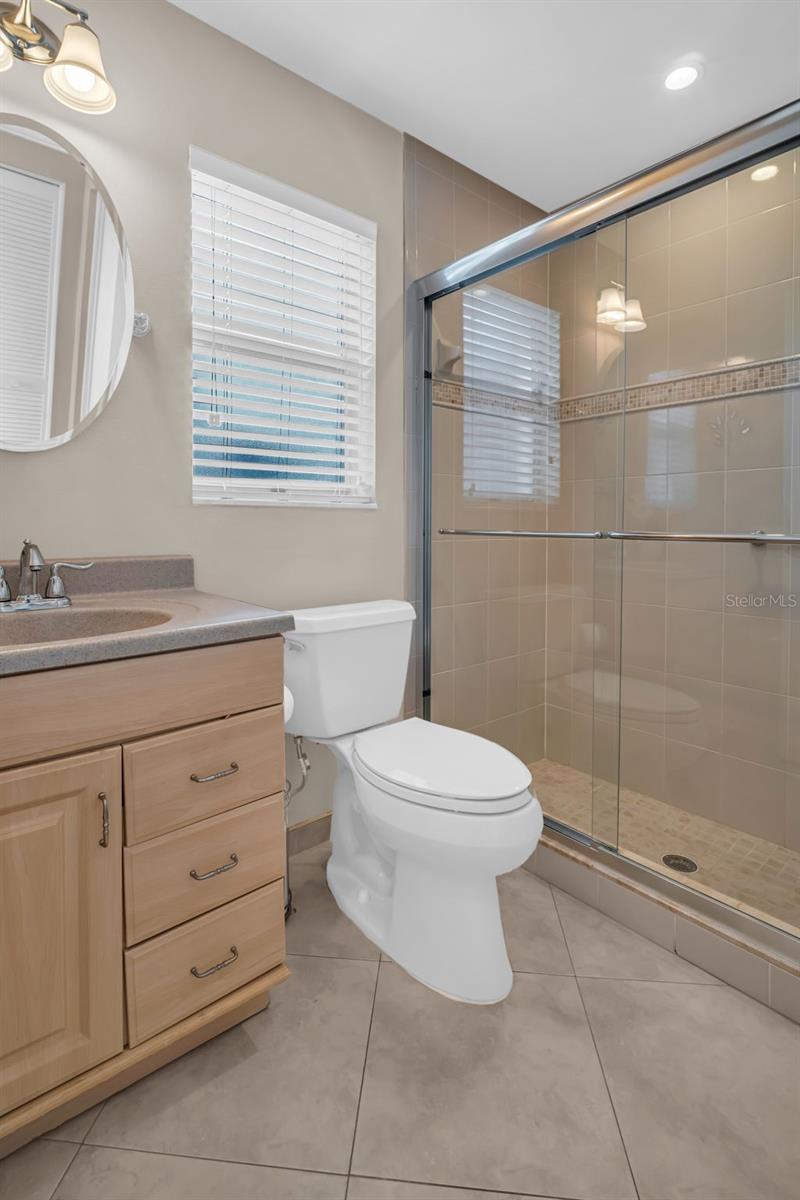 Updated en suite with step-in shower & sturdy glass doors~