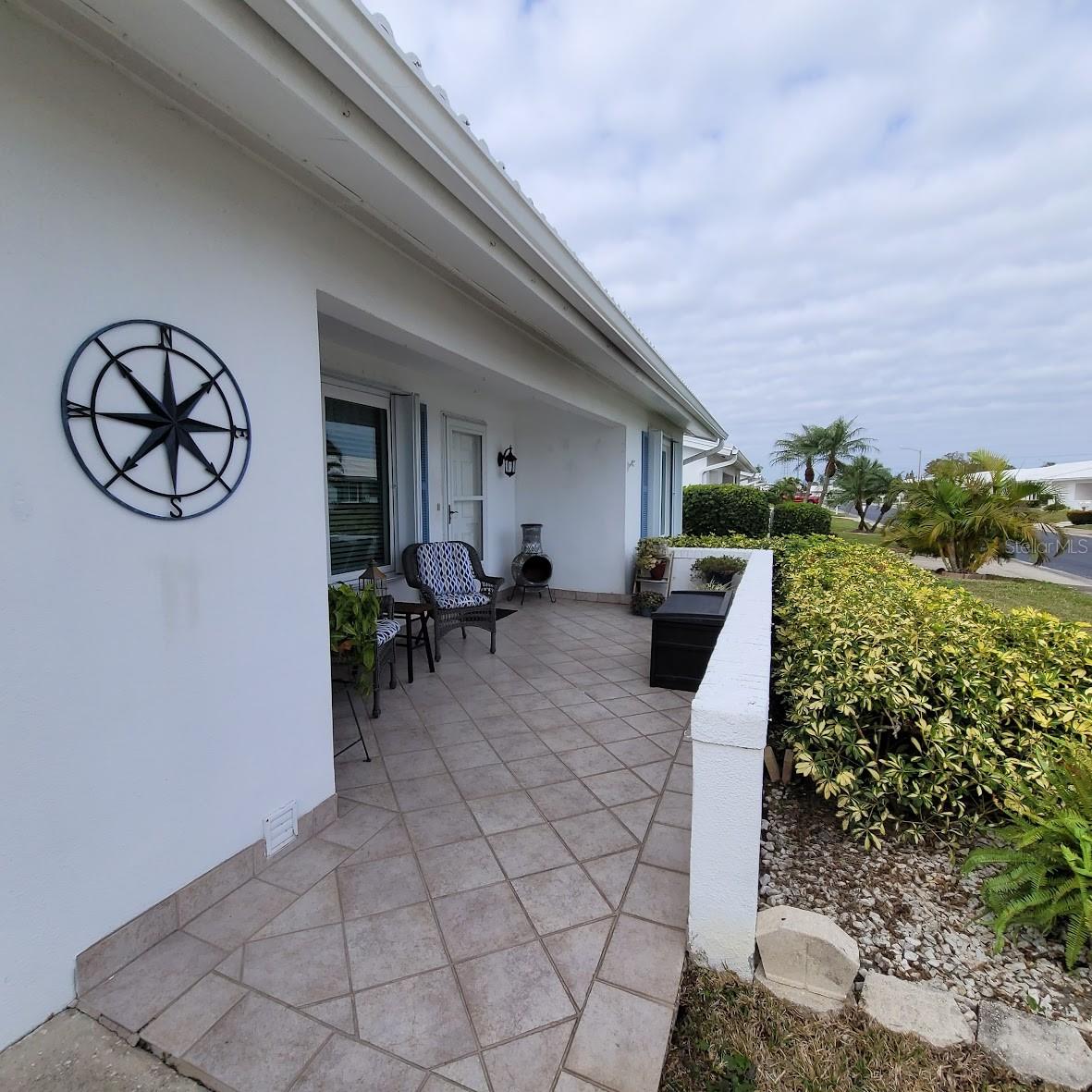 Enter the home from this welcoming front porch. Imagine yourself visiting here with friends and family, or perhaps with a good book.