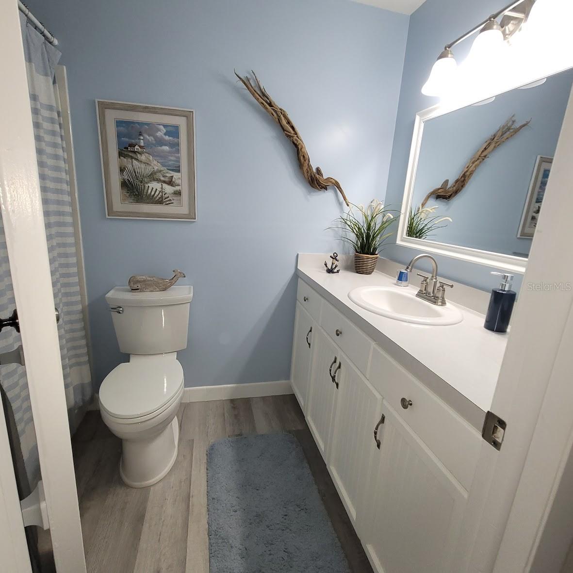 The guest bathroom is beautiful with the coastal blue colors and decorations.