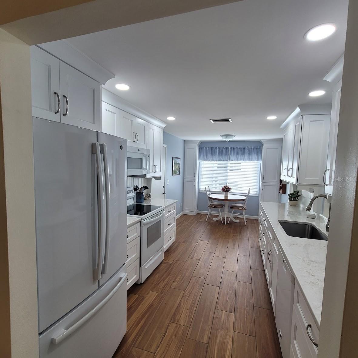 Just off the dining area is this beautifully remodeled 9X20 kitchen. Between the lighting, new wood cabinets, newer appliances, quartz countertops and wood looking Tile Floors. This kitchen will be a dream to work in!