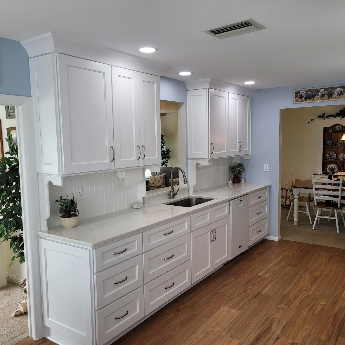 The cabinets and counter space make this a wonderful kitchen to bake in as well. Notice the pass through to the family room for when entertaining. Proximity to the Dining Area as well. You can also see the doorway to the den / office which is just off the kitchen.