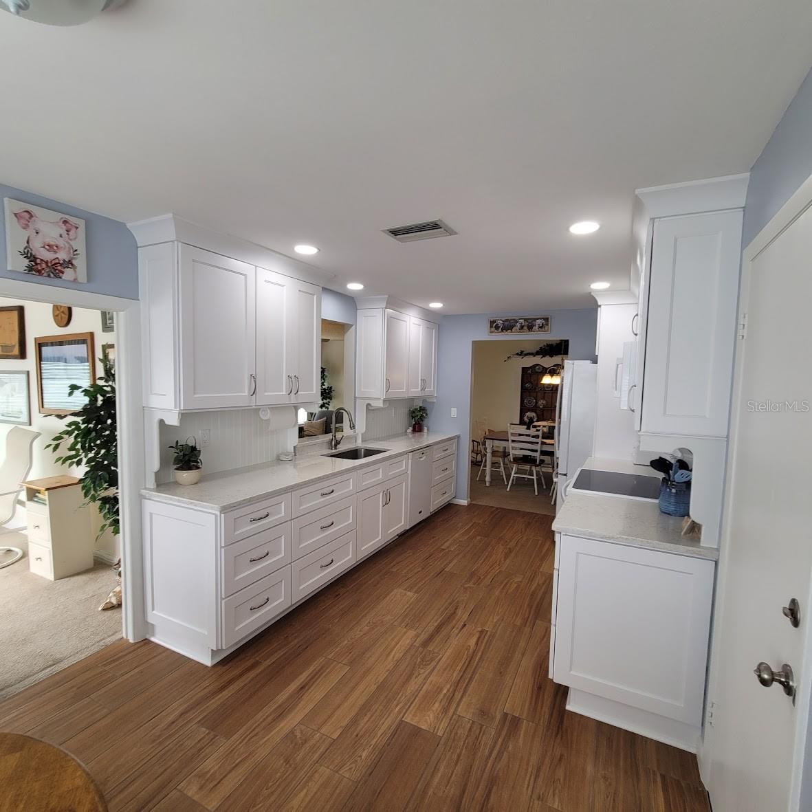 The door to the right leads to the garage making it easy to transport groceries into the home.  Another quick peek at the office as well.