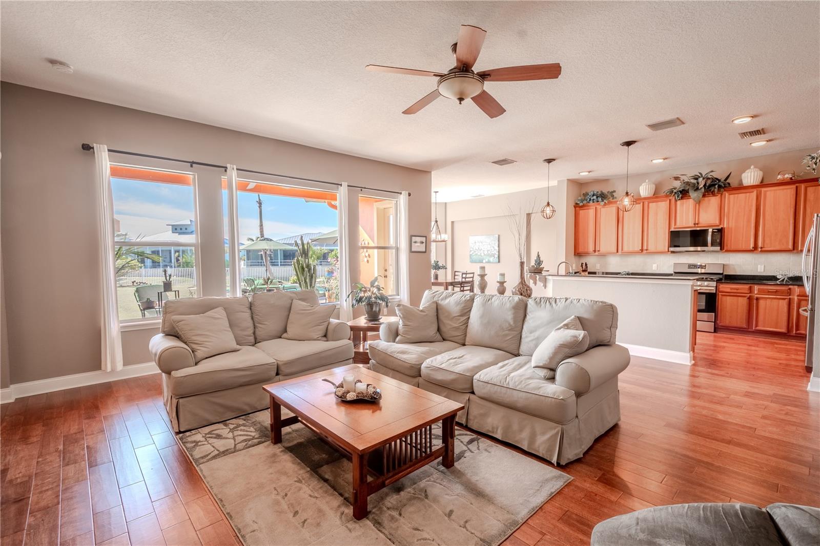 The living/family room is open to the kitchen and has a large (hurricane impact) window providing an abundance of natural light.