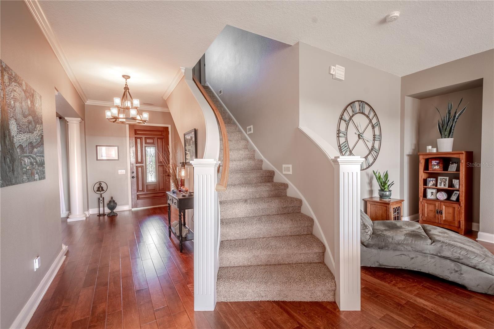 Curved, carpet stairs with wood banister lead to the 2nd floor.