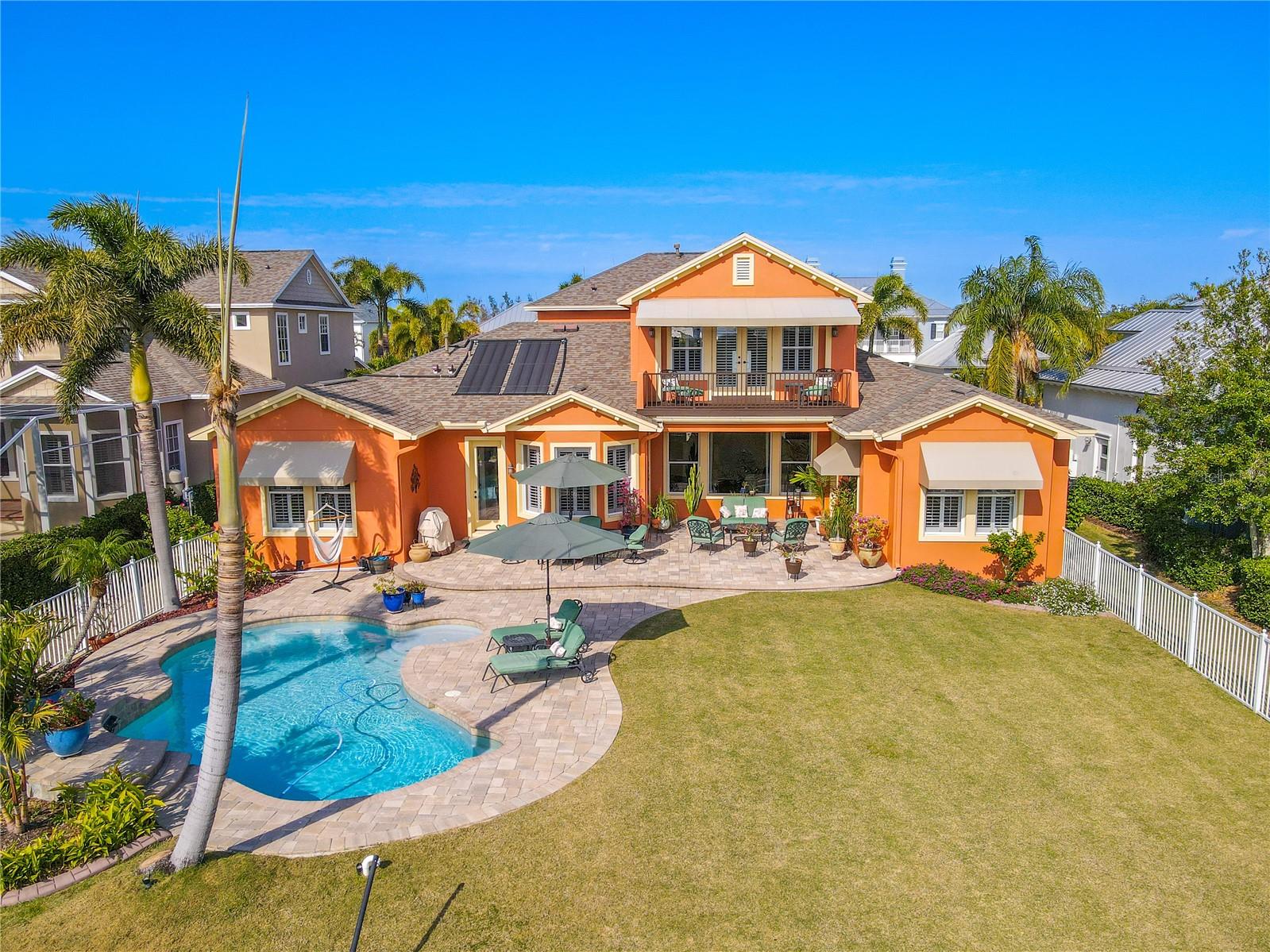 The pool and backyard are beautifully manicured and lushly landscaped.