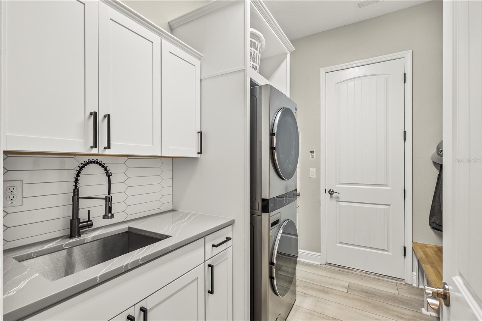 Laundry Room with sink and LOADS of custom-built-ins for Max Organization!