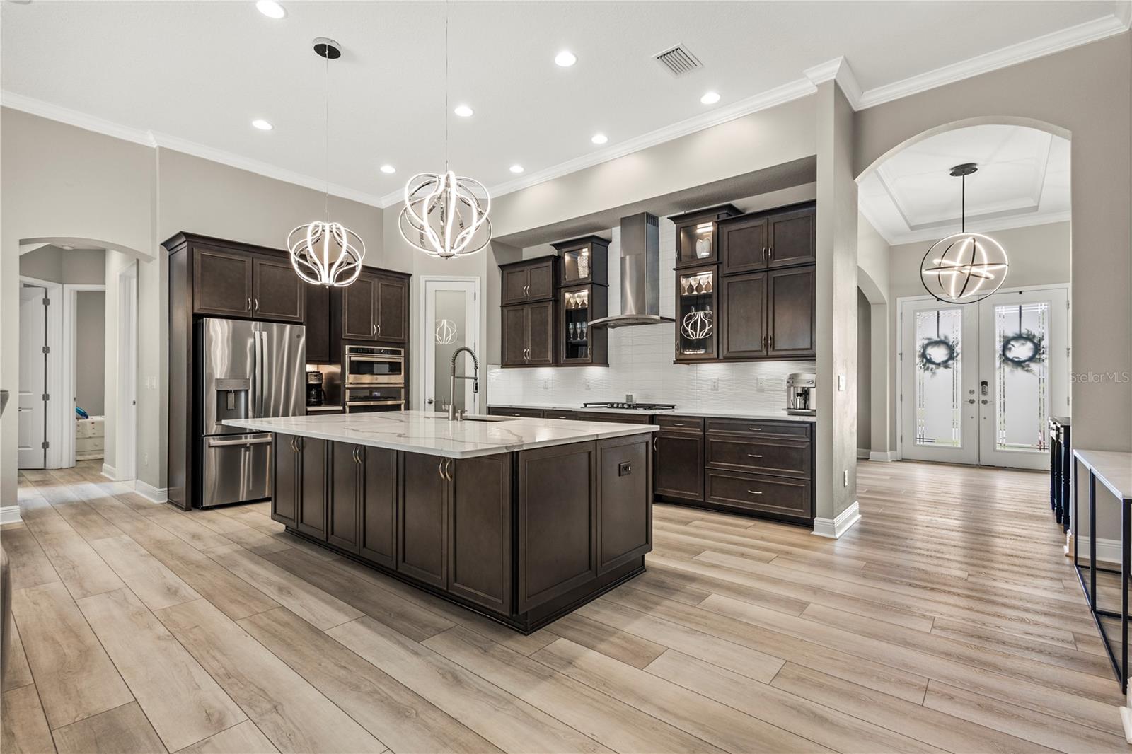 Gourmet Kitchen with a HUGE quartz island and double stacked cabinets