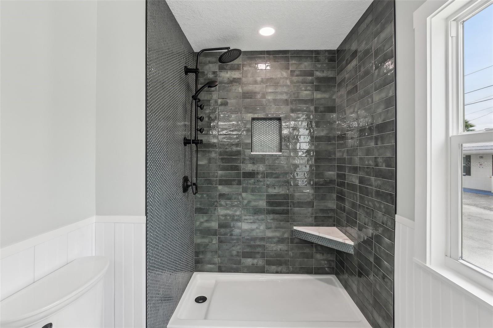 Gorgeous shower with built-in seat.  You can choose how to customize it from here.