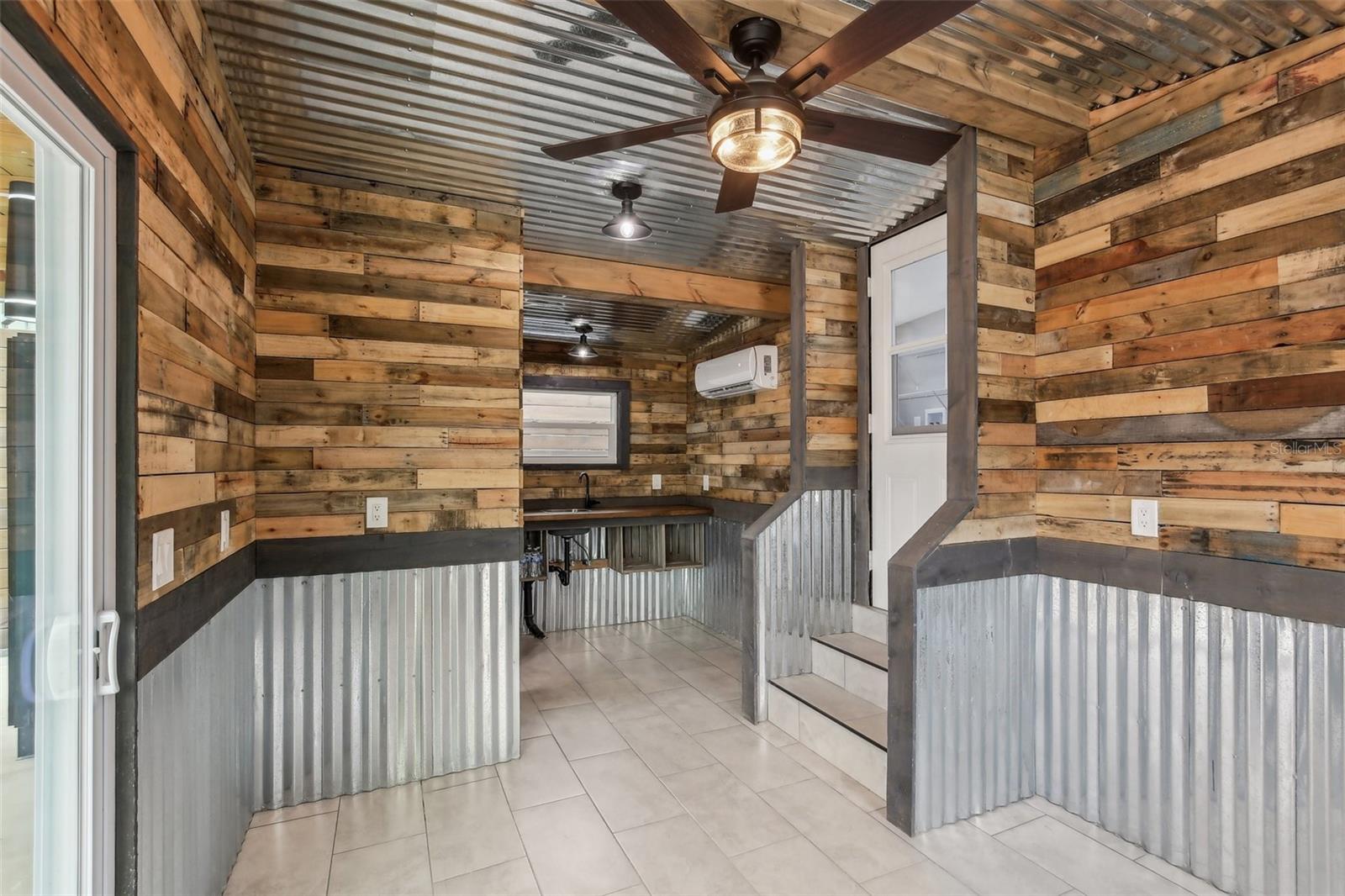 Bonus room with an additional 1/2 bathroom, mini-split HVAC unit, and kitchenette.