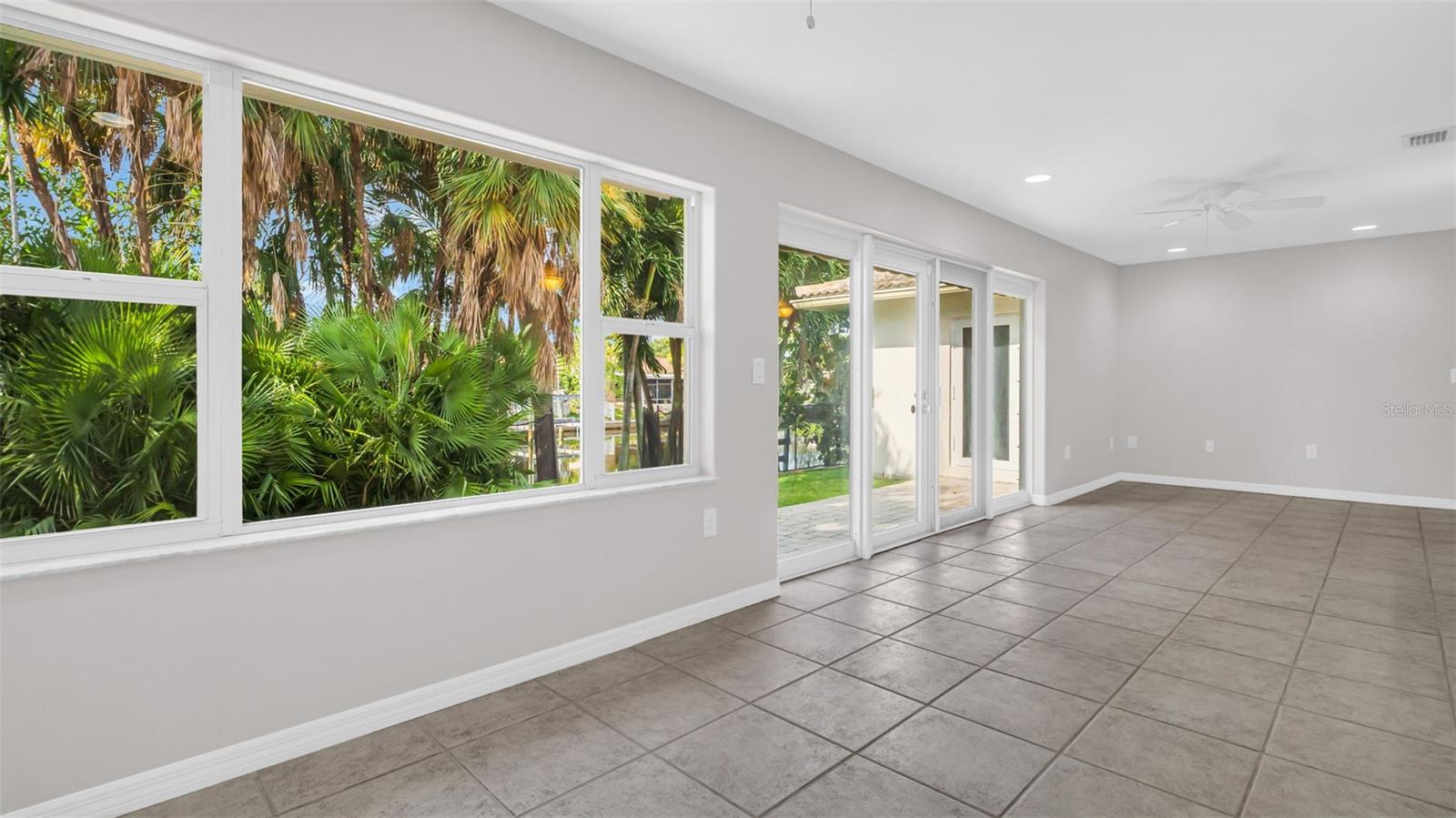 Large sunroom overlooking the canal and lush yard