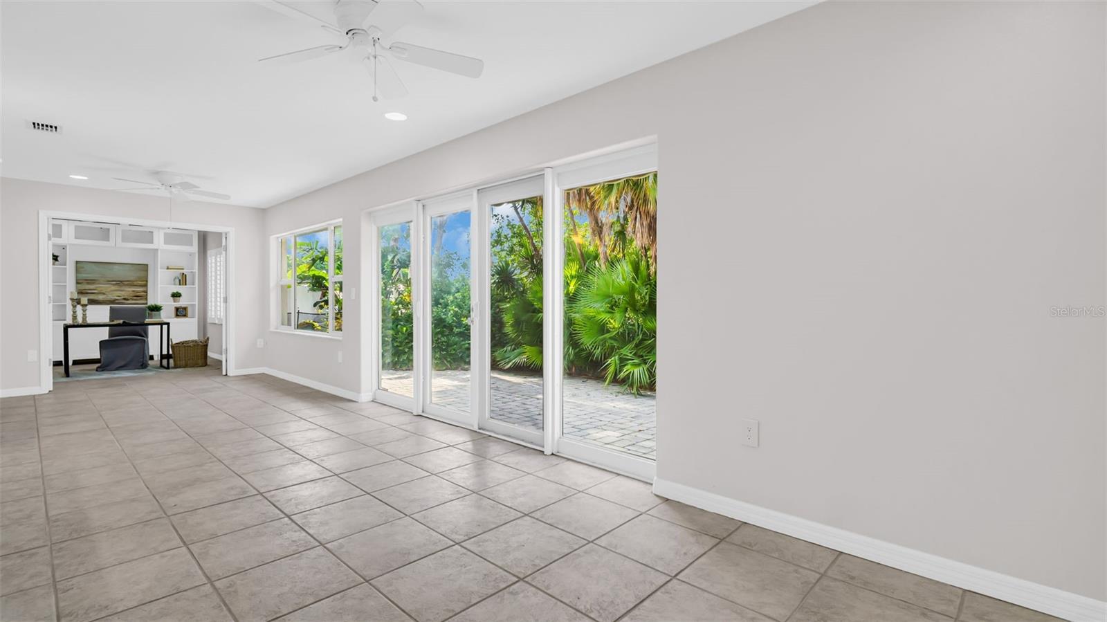 Large sunroom overlooking the canal and lush yard