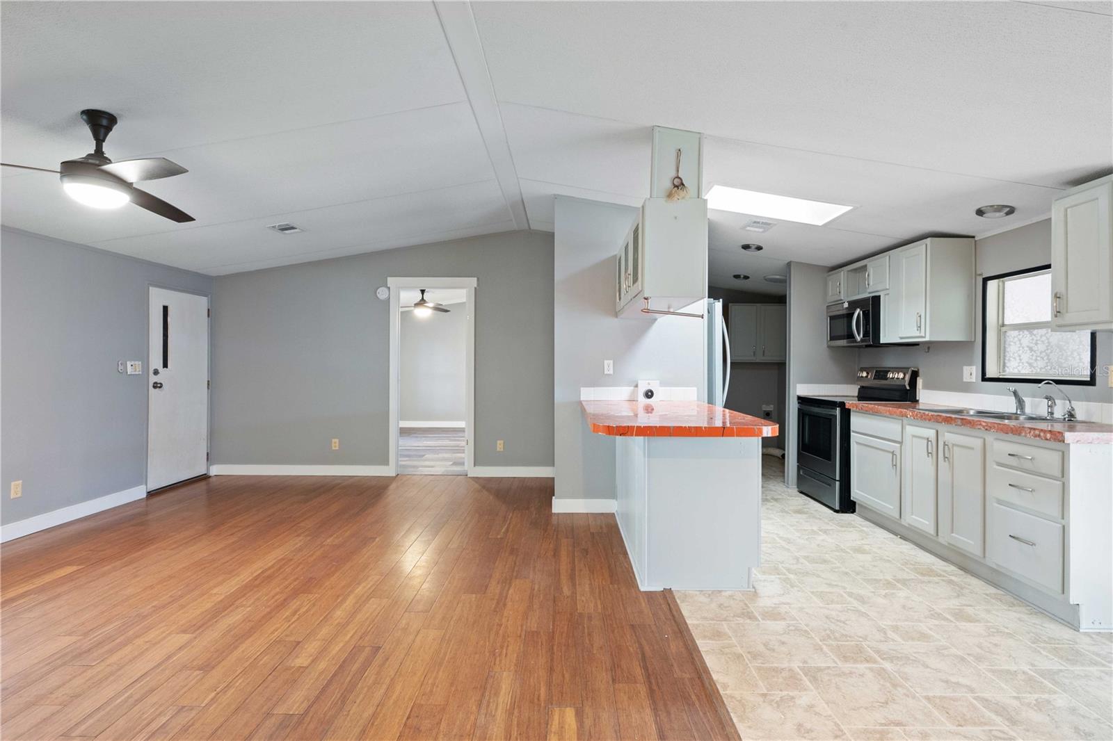 Living room is open with kitchen and dining area.