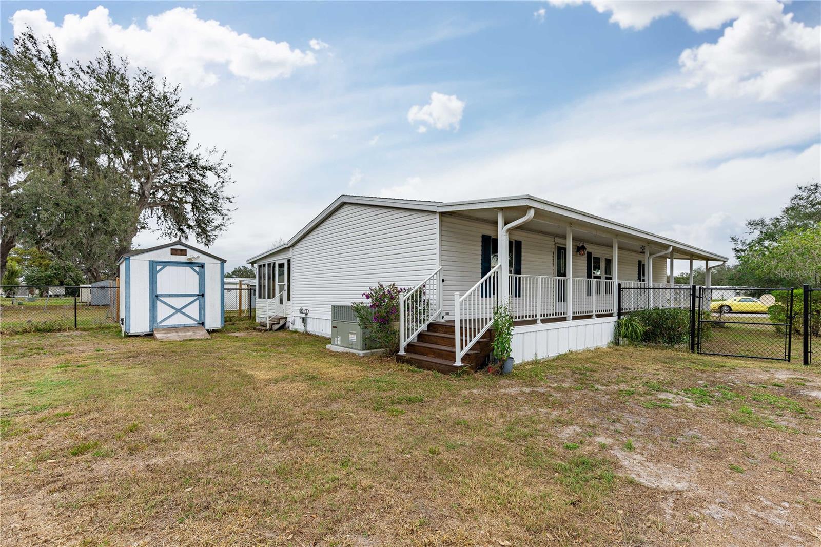 Storage shed and large side deck on this home.