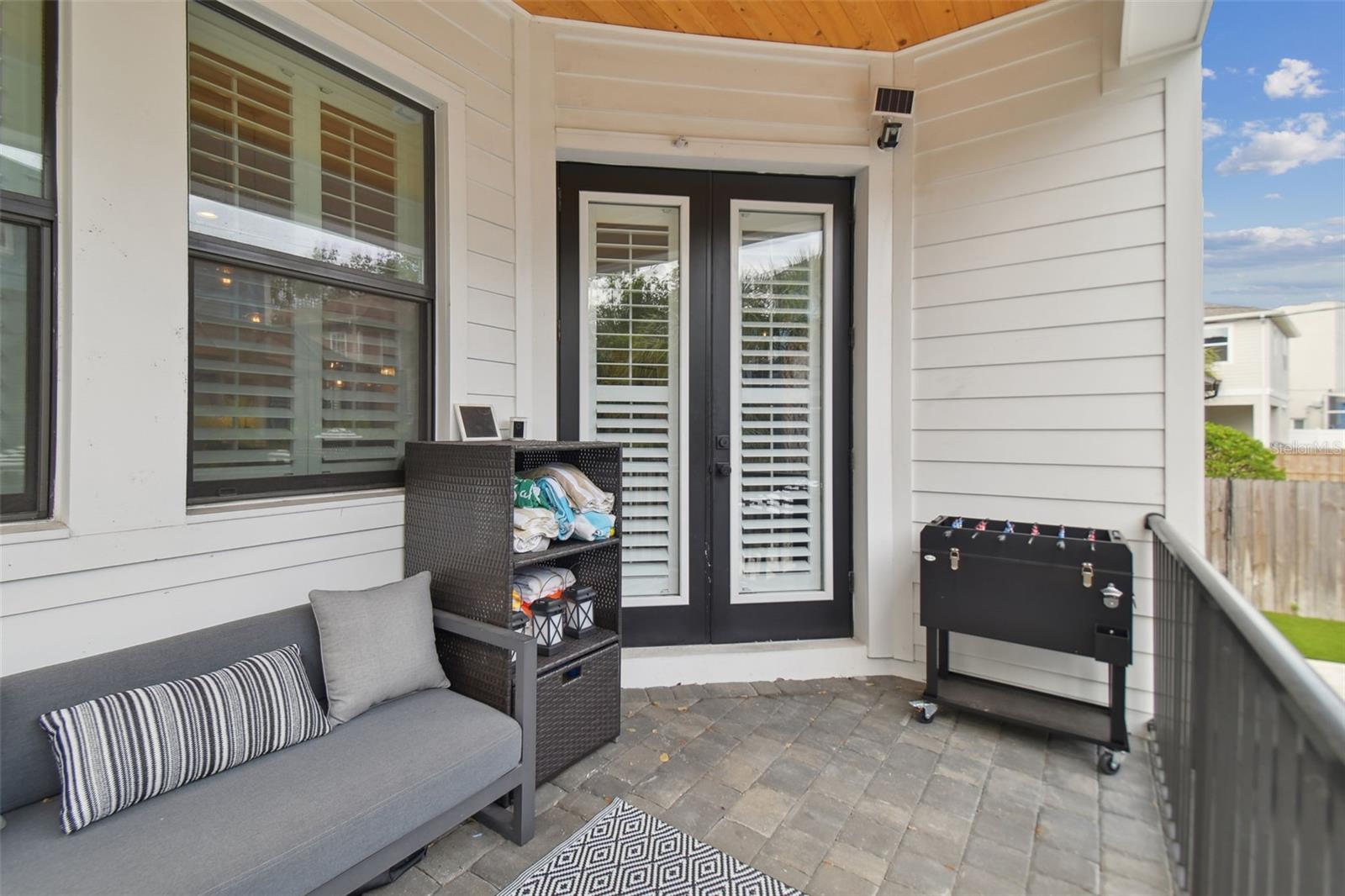 Covered Back Porch with French Doors Leading to Living Room