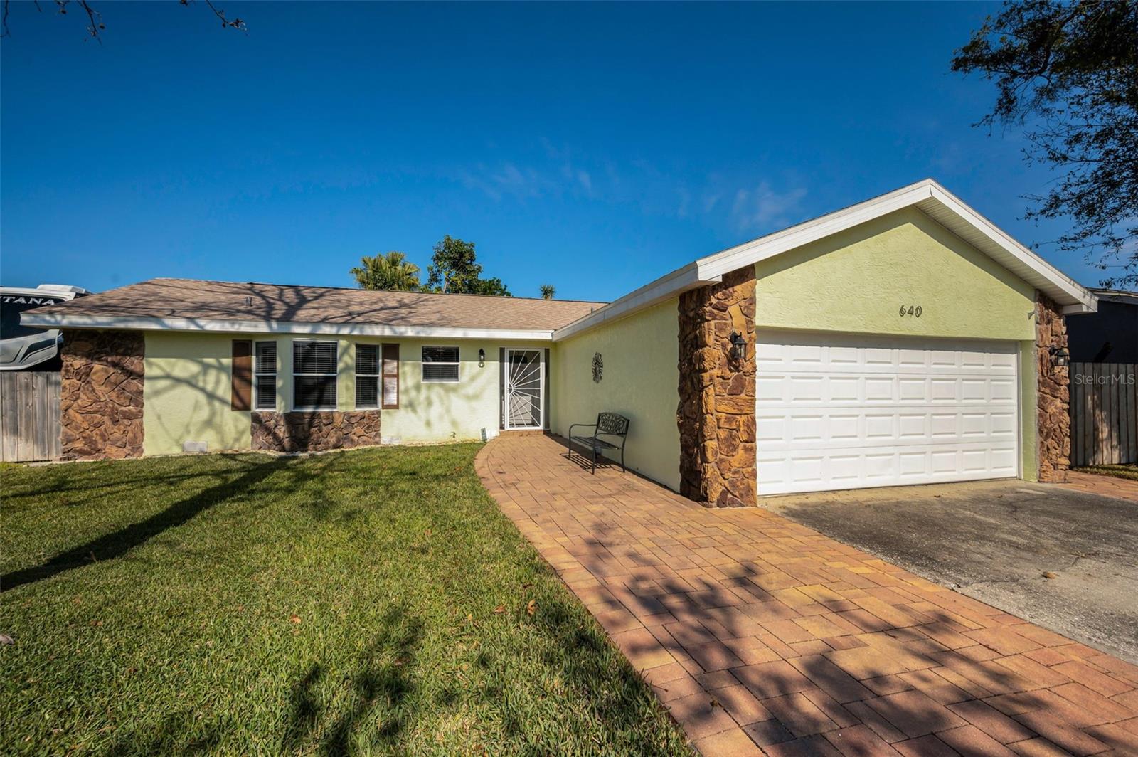 Welcome to 640 Kirkland Cir, A METICULOUSLY WELL CARED FOR HOME, a delightful 3 bedroom, 2 bath, 2 car garage Dunedin home with RV STORAGE and a huge back screened lanai!