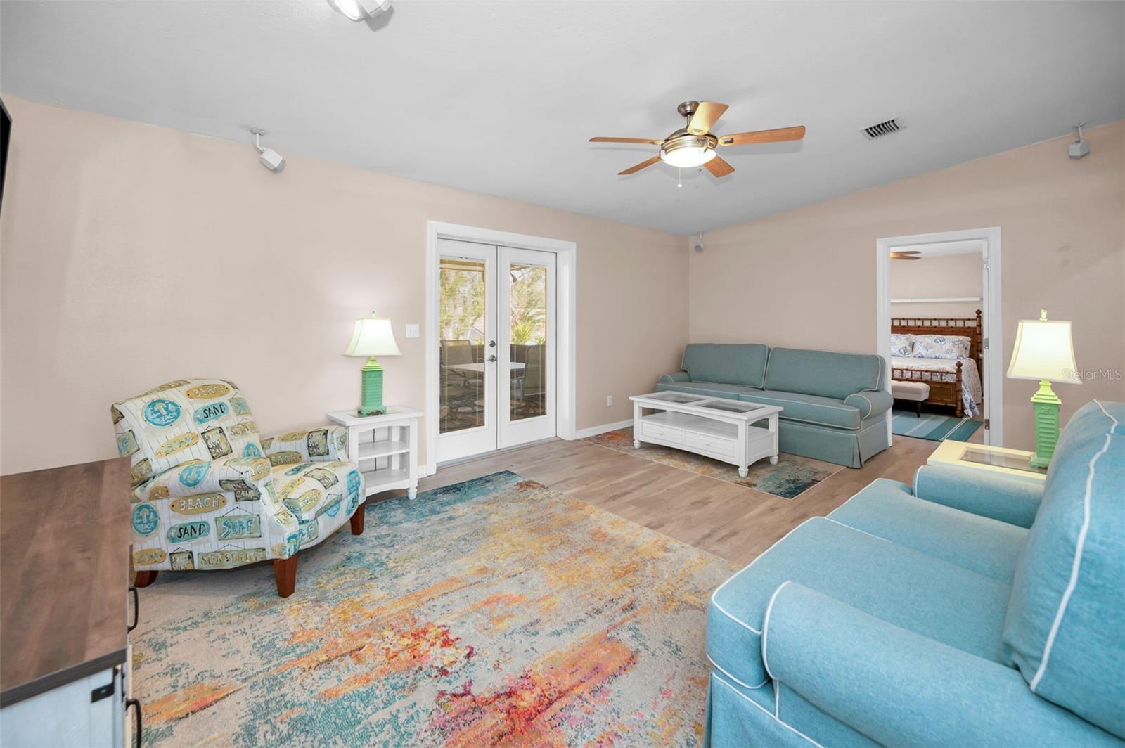 SECOND BACK BEDROOM OFF LIVING ROOM AND ENTRANCE TO EXPANSIVE SCREENED IN LANAI