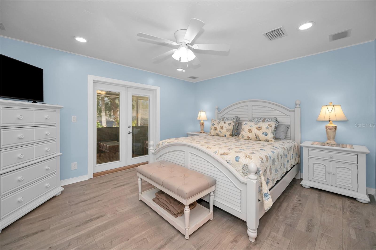 PRIMARY BEDROOM WITH ENTRANCE TO EXPANSIVE BACK SCREENED IN LANAI