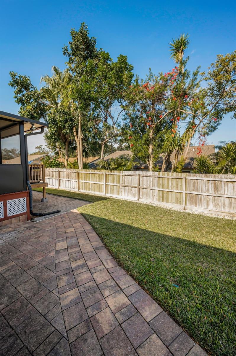 OWNERS ADDED EXTRA PAVERS FOR AN EASY WALK FROM THE SIDE OF THE HOUSE TO THE BACK OF THE RAISED LANAI.