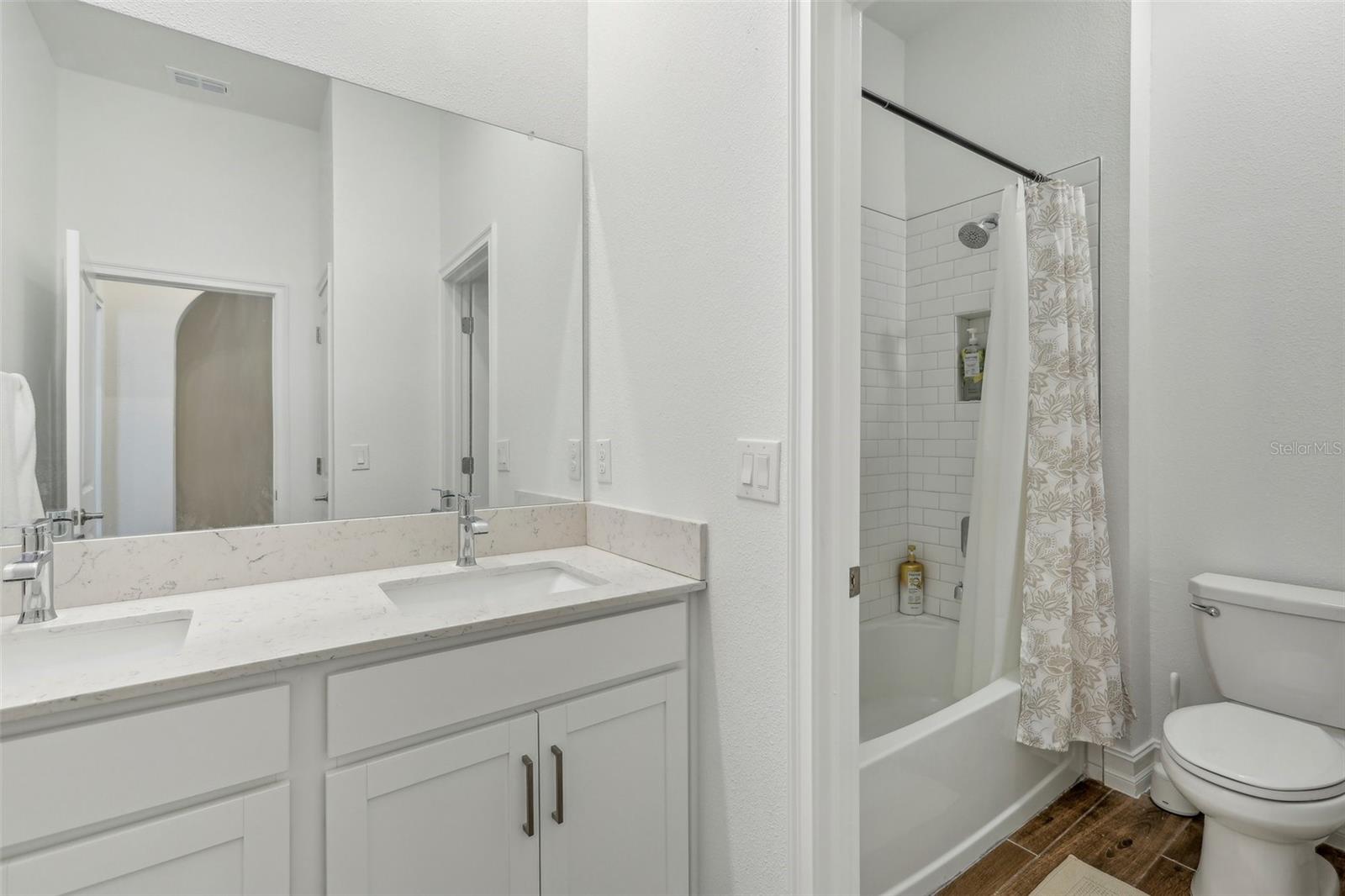 bathroom 2 (double sinks) and separate shower tub and toilet