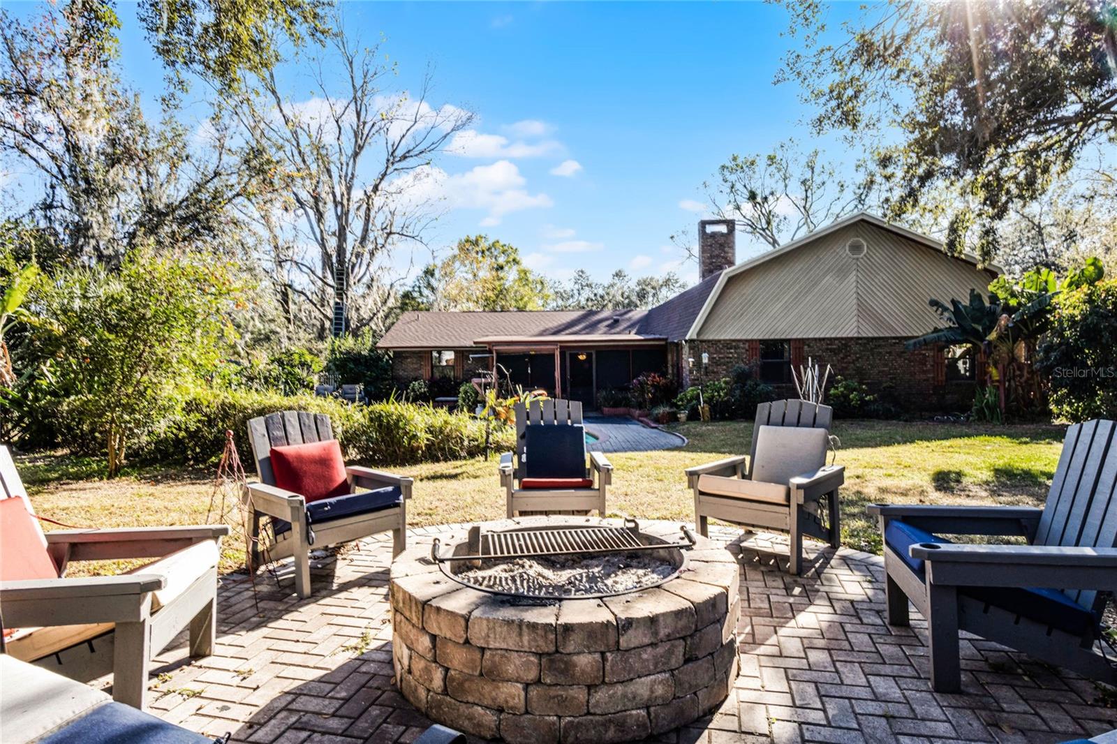 Fire Pit in large yard overlooks the home and pool