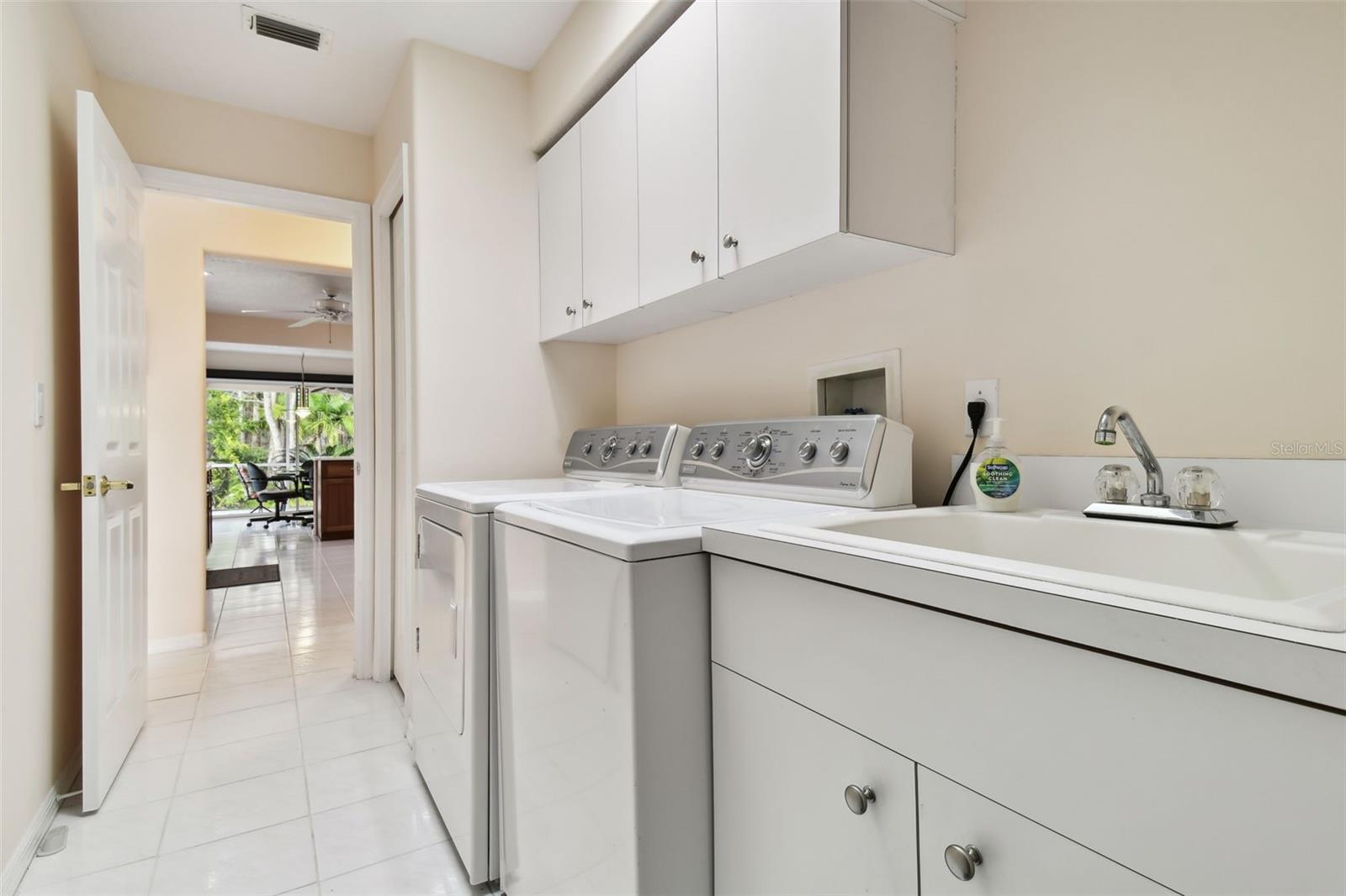 inside laundry room with a skylight that leads to the kitchen or the garage!