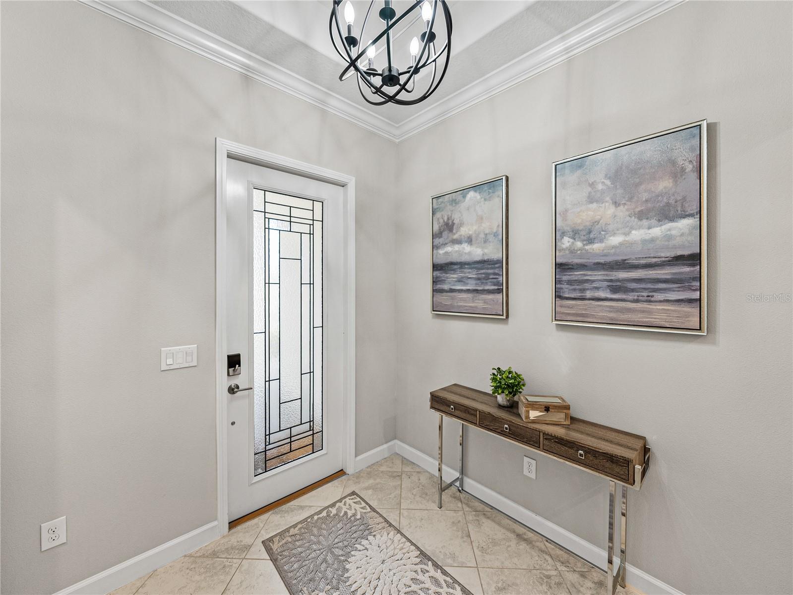 Beautiful Glass Door insert, upgrade!  The glass is Hurricane Impact and allows natural light to flood the entry of this grand home.