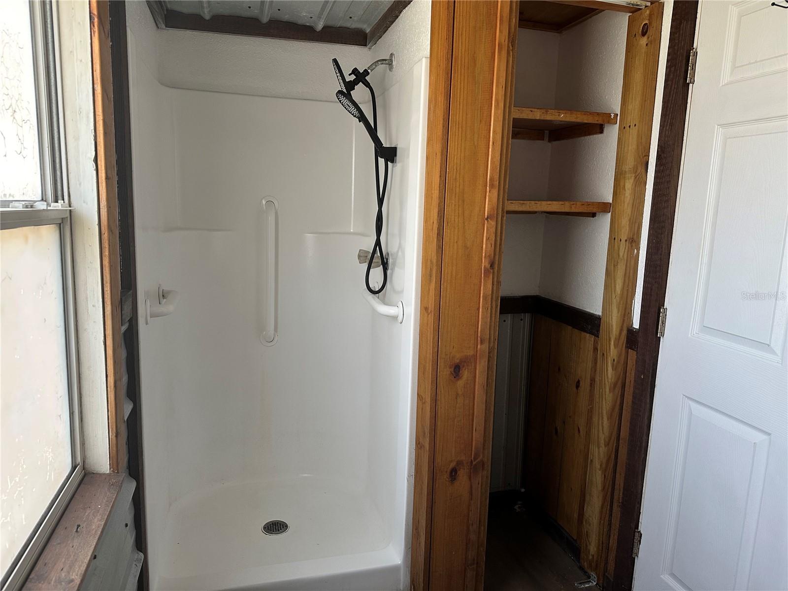 Shower with cabinet space.