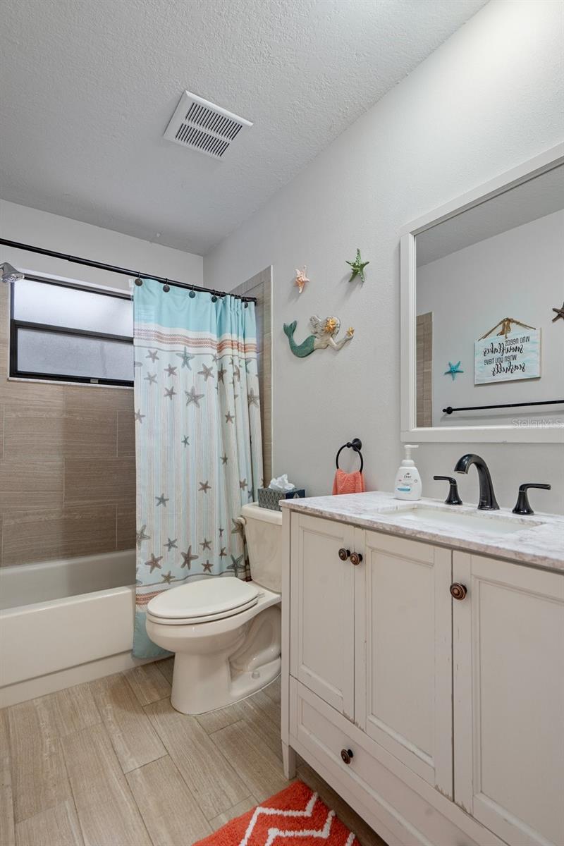 Updated Guest Bath with Tub and Tiled Floor