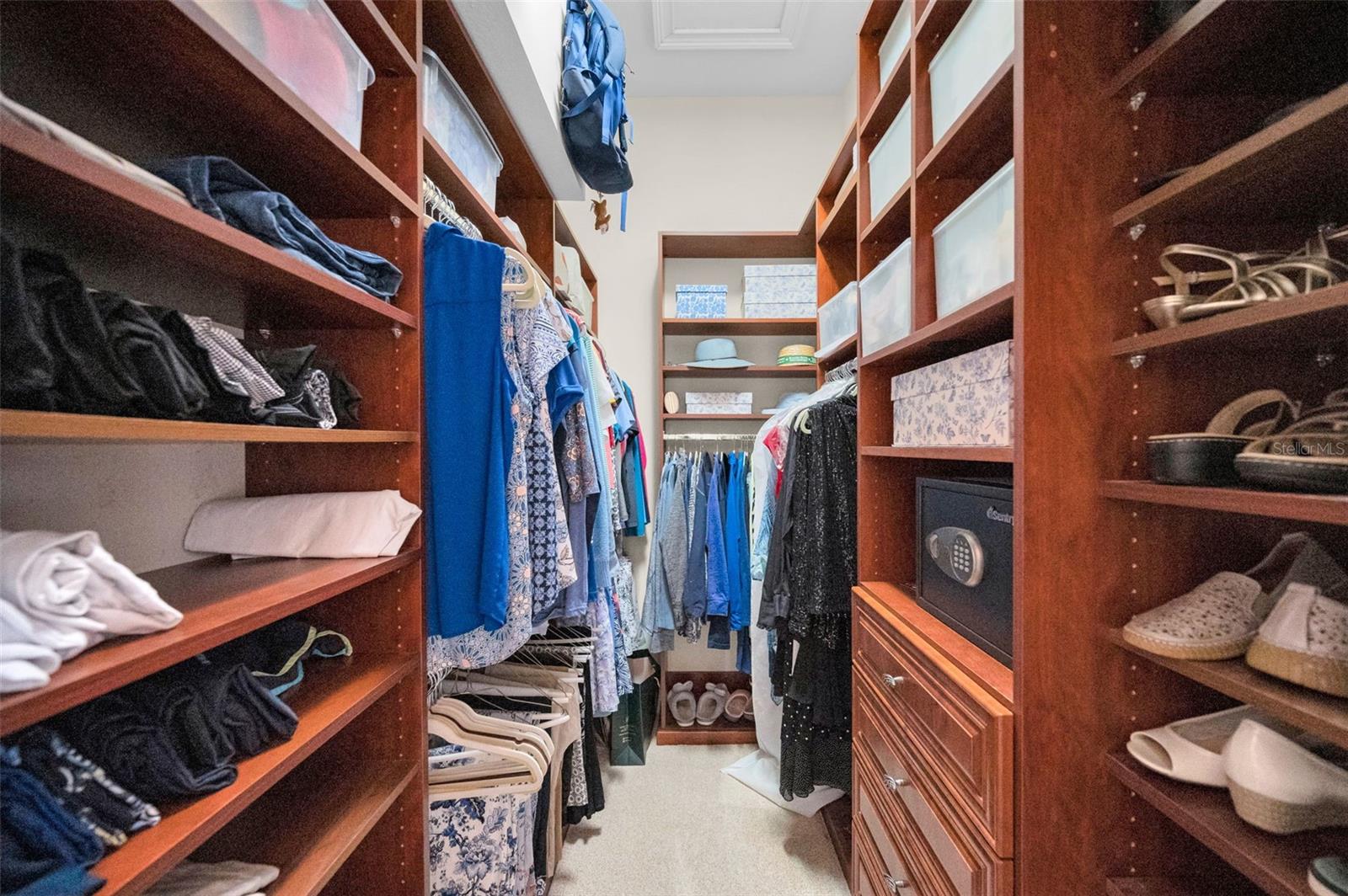 his and hers private closets with built in shelves