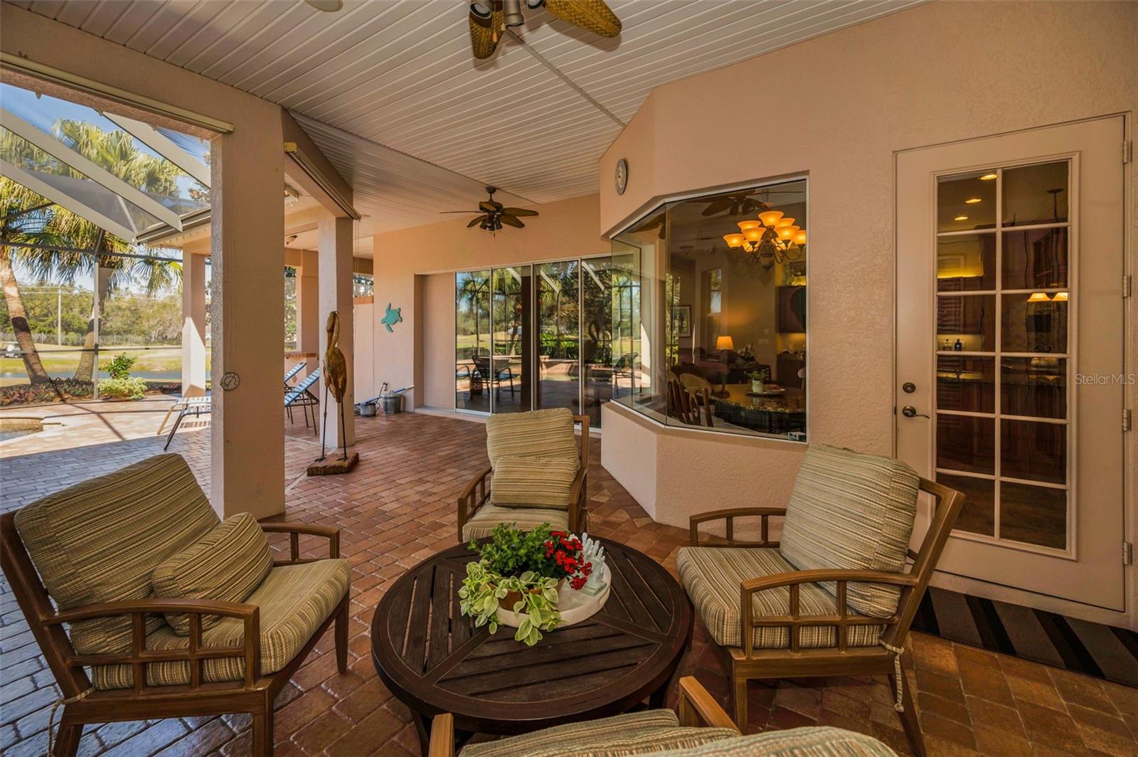 porch with ceiling fans and pavers