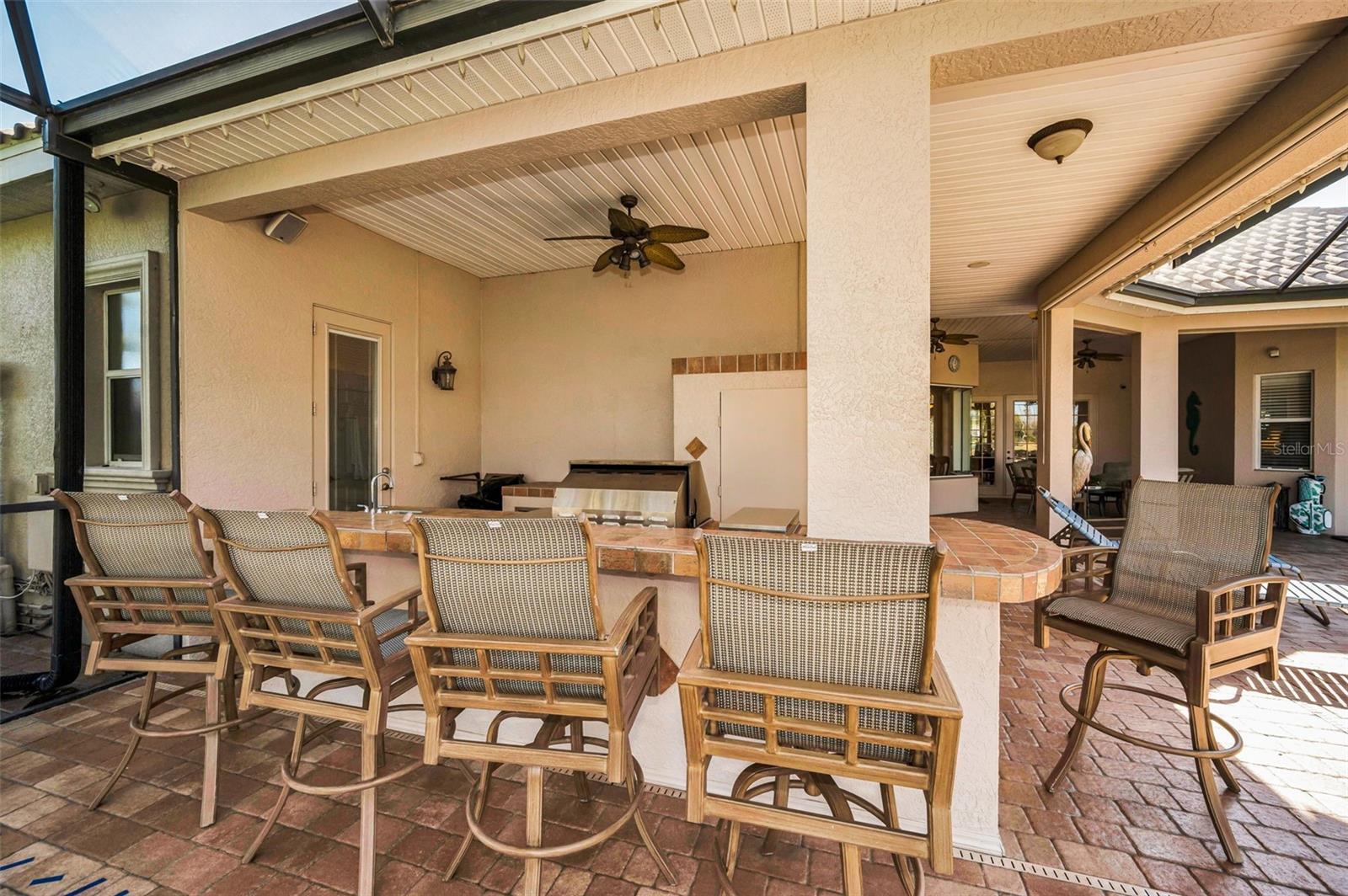 Outdoor kitchen with sink, grill and massive storage