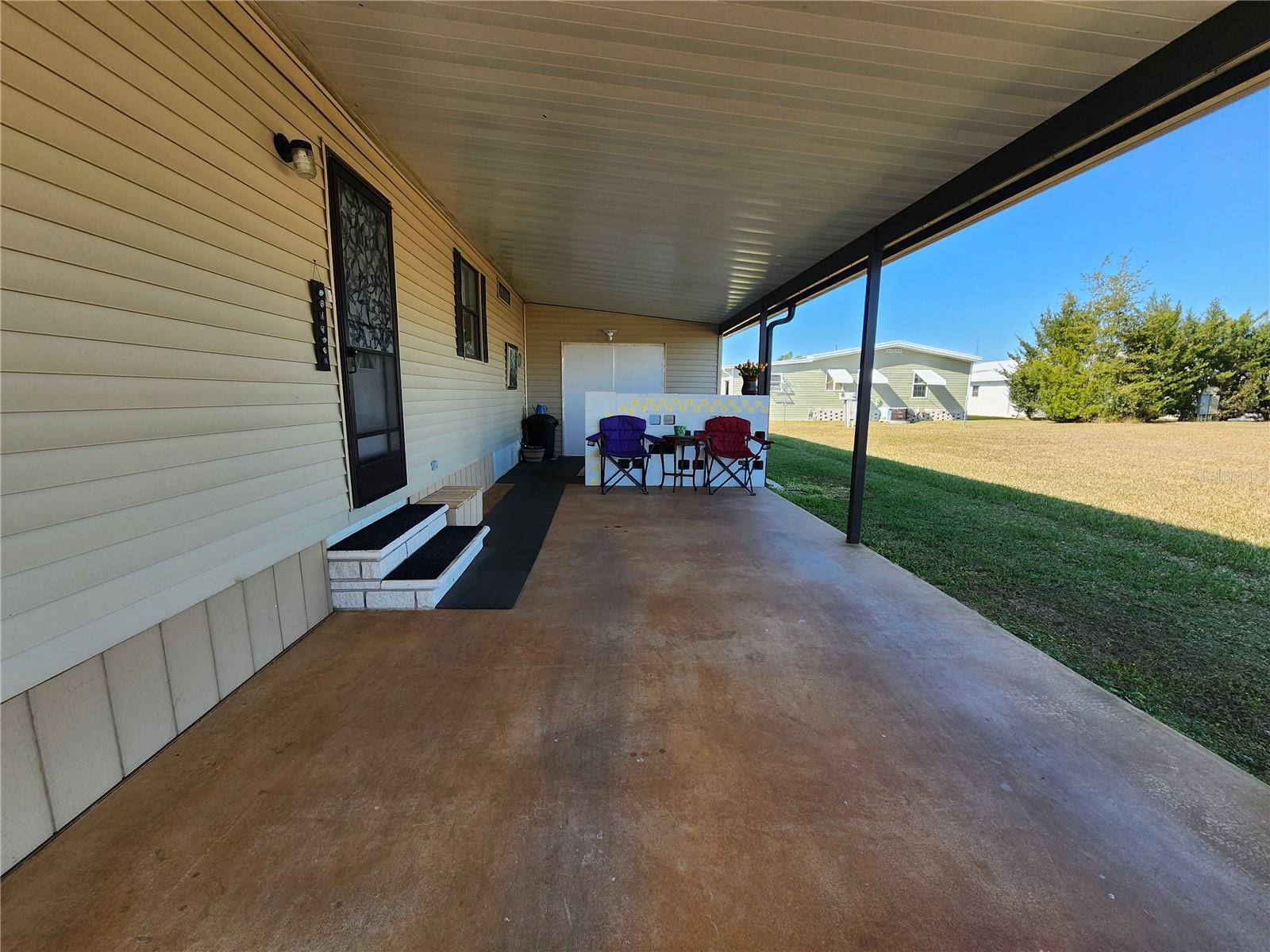 Carport & entry door to Kitchen.