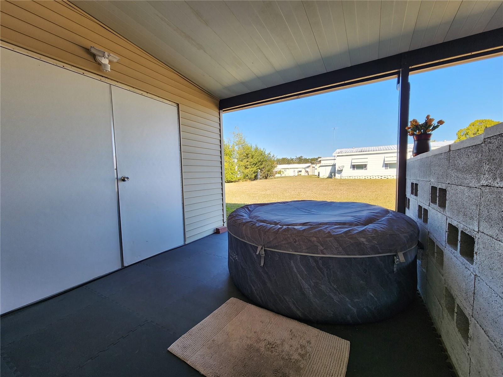 Portable hot tub and attached utility room entry.