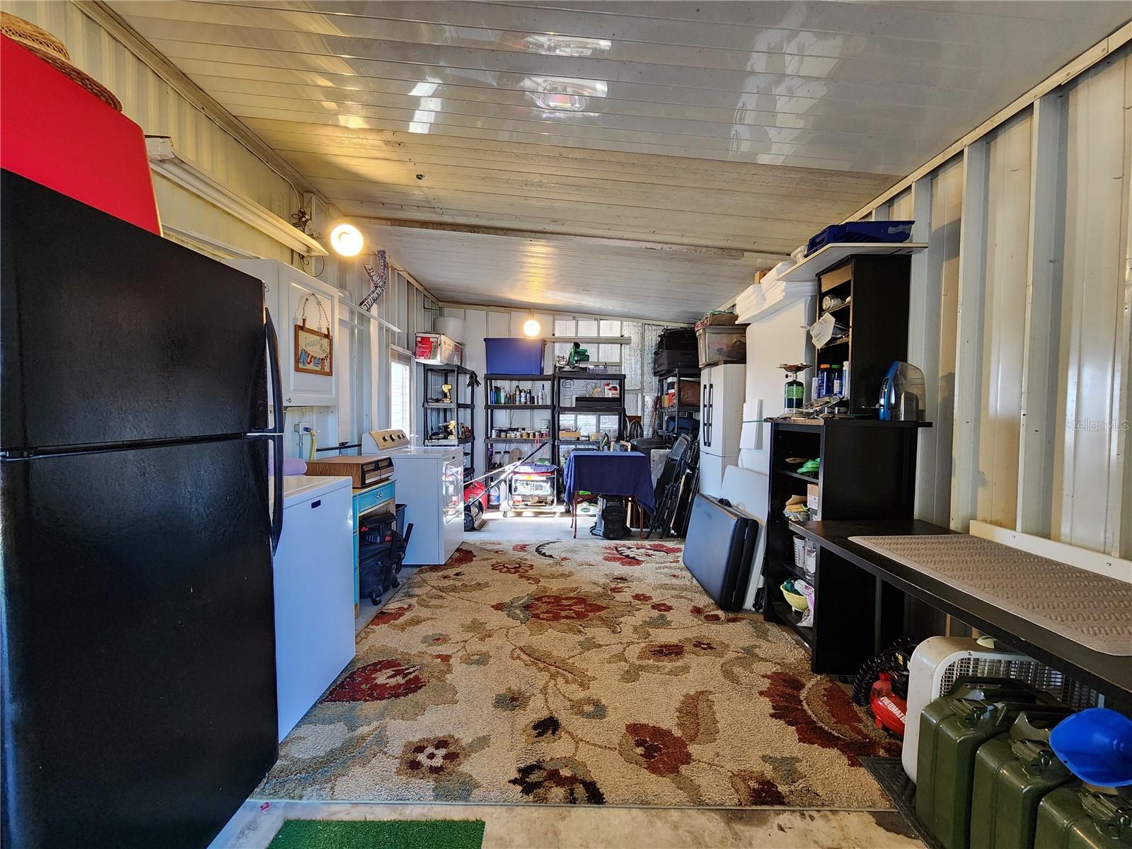 Attached utility room with extra refrigerator and washer/dryer.