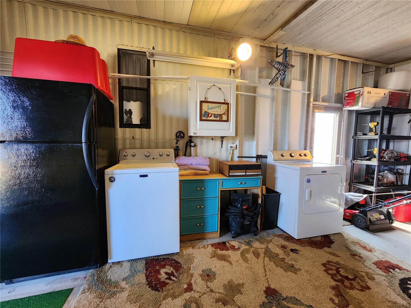 Attached utility room with extra refrigerator and washer/dryer.