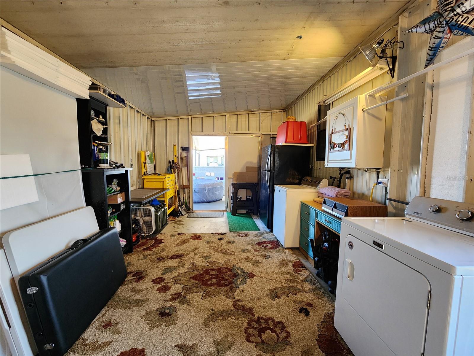 Attached utility room with extra refrigerator and washer/dryer.