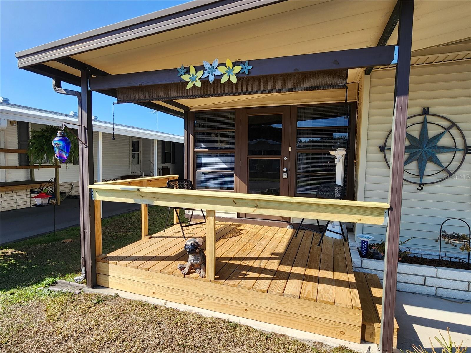 Covered front deck & Florida room entry.