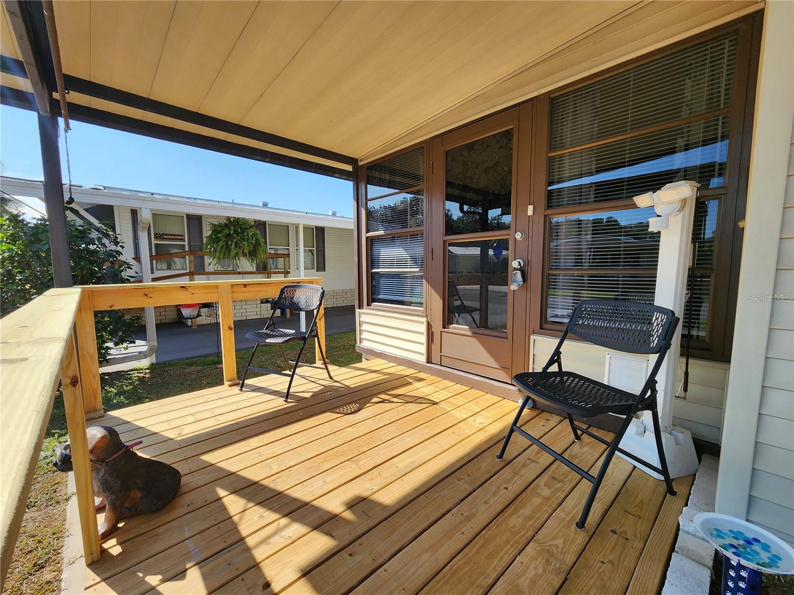 Covered front deck & Florida room entry.