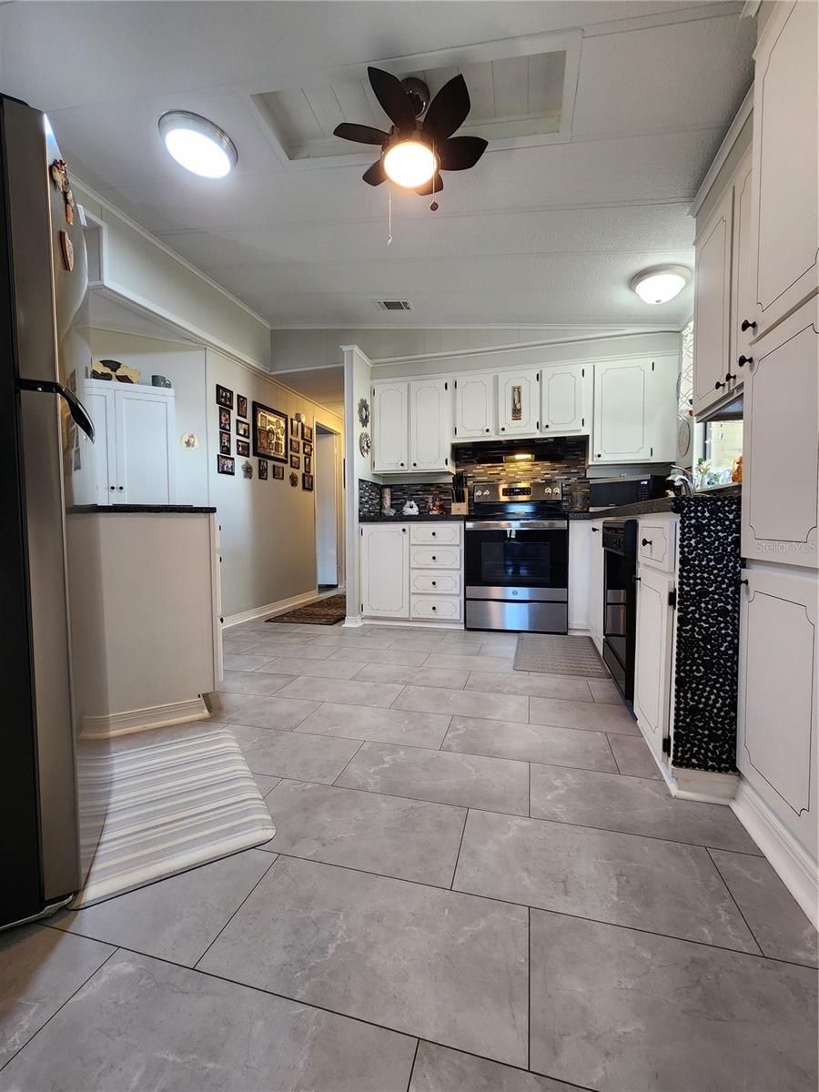 Kitchen with updated appliances & pantry.