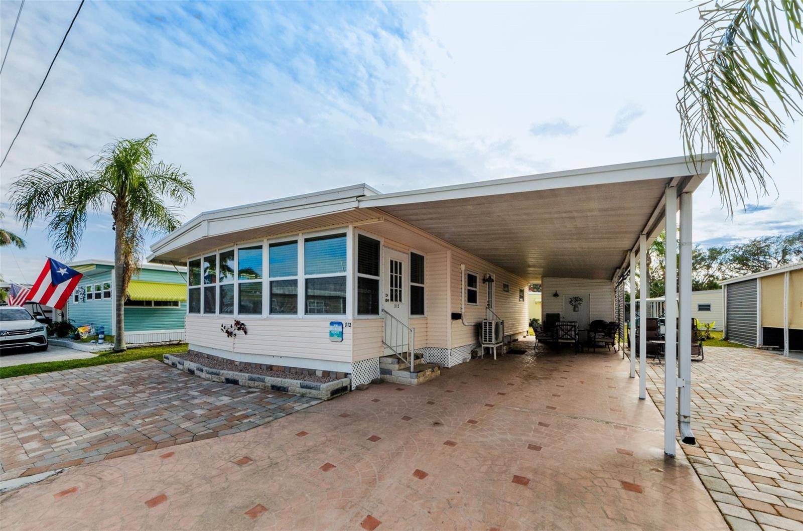 Front entrance with carport and pavers for extra parking