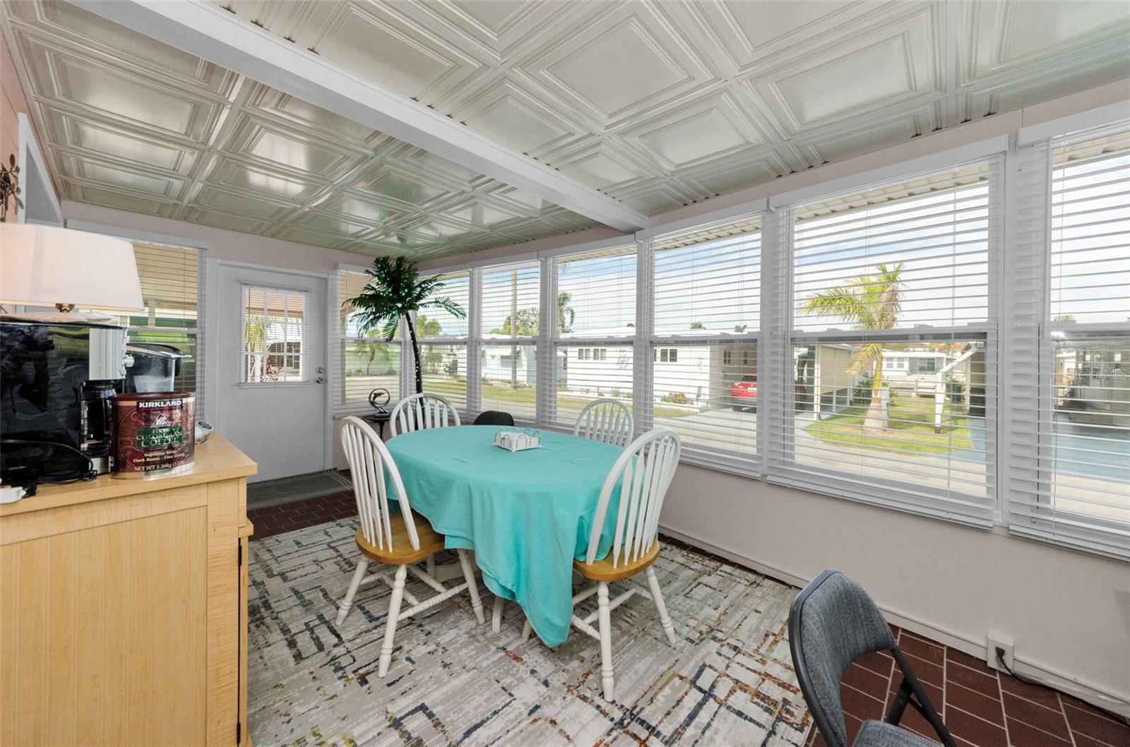 Sunroom with coffee bar and tons of natural light which is a perfect place to sip your coffee and read the paper.