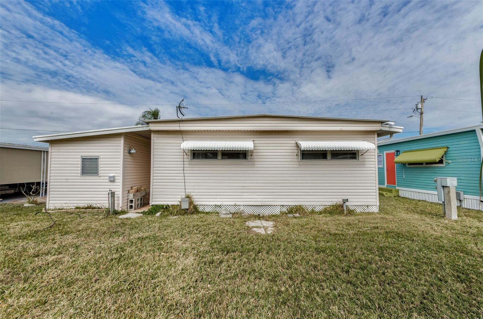 Back of unit with awnings and room for a small patio