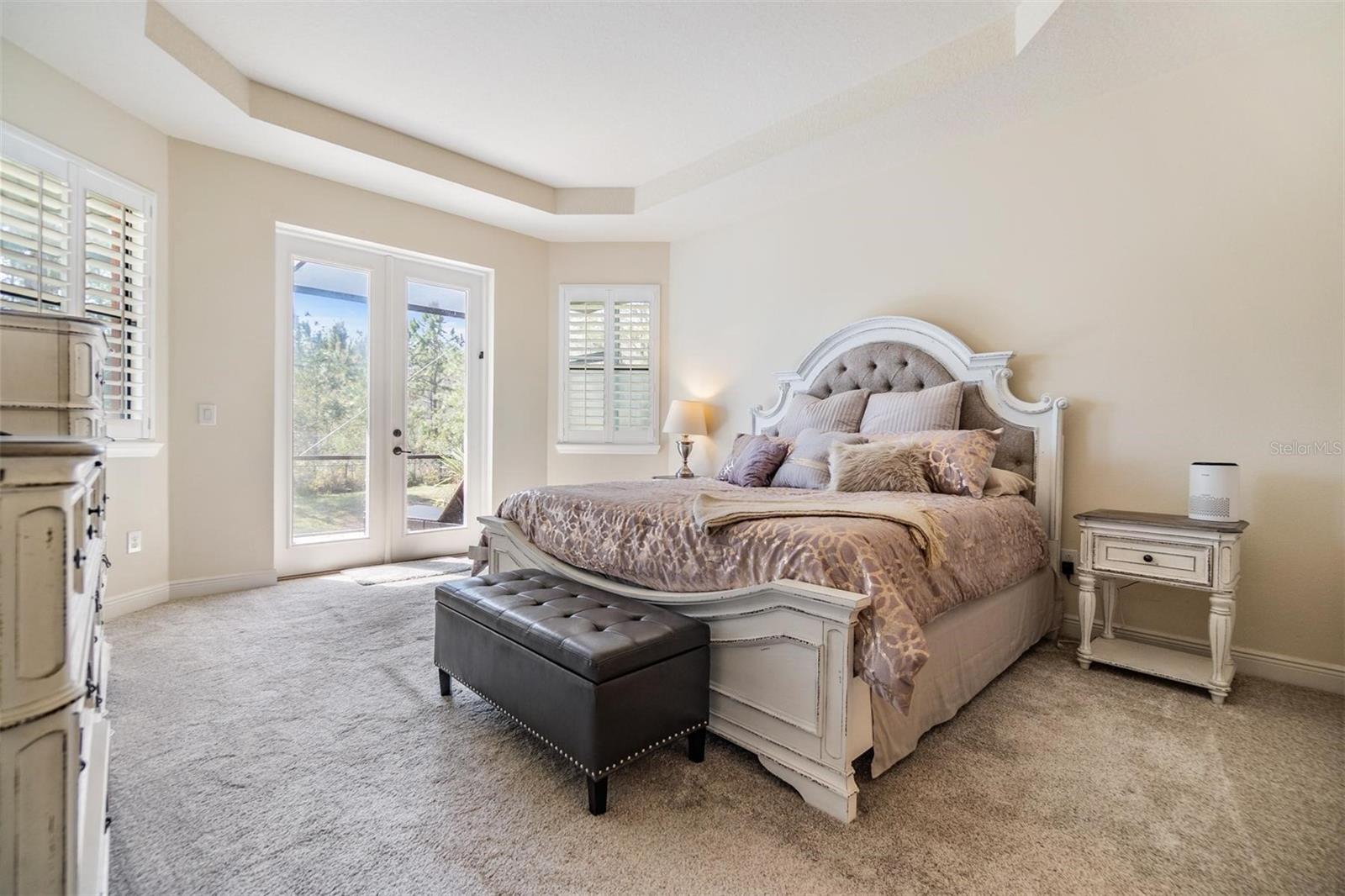 Master bedroom provides direct access to lanai through the French doors