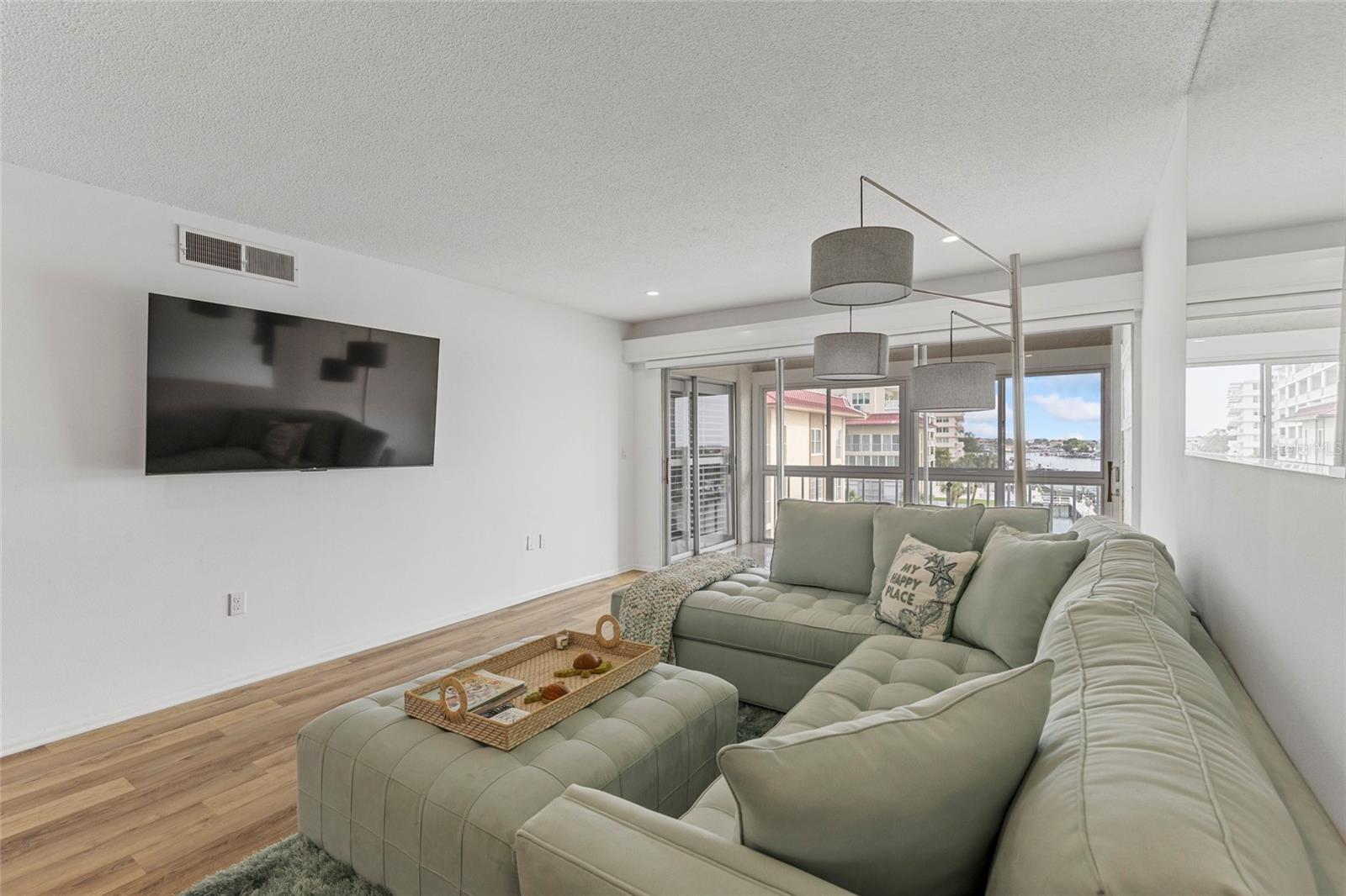 living room with water view and tv while sitting