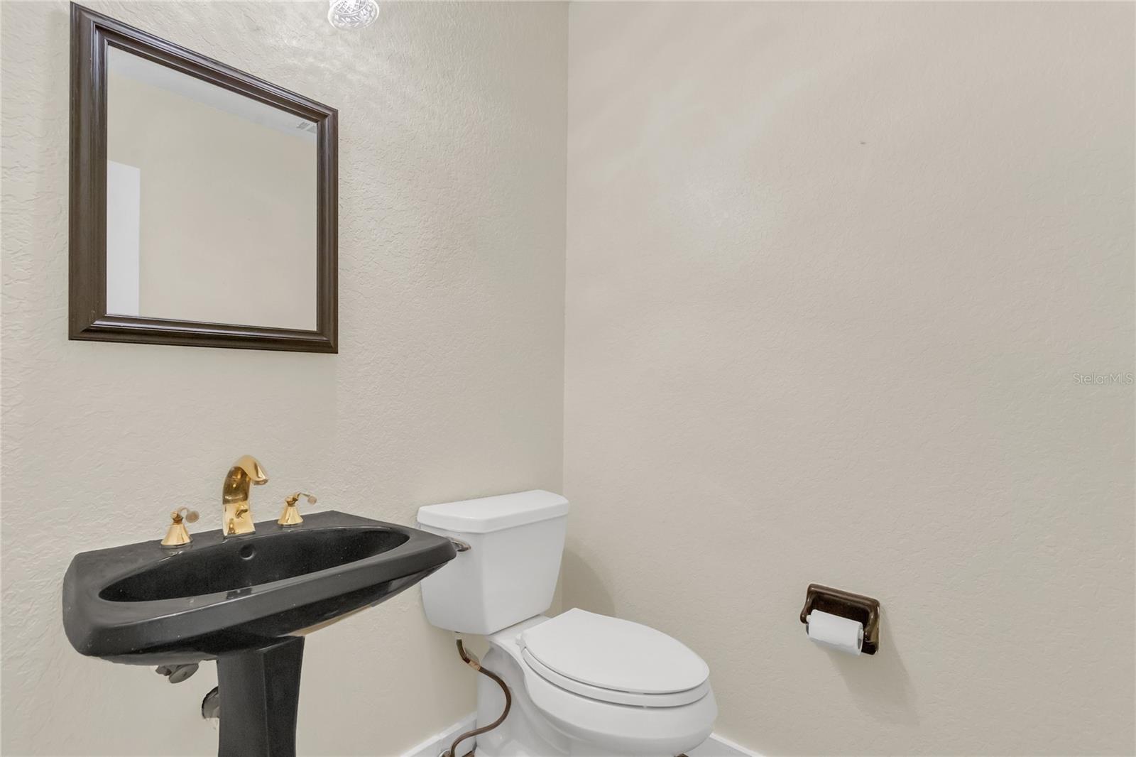 Powder Room in hallway down from Library/Lounge