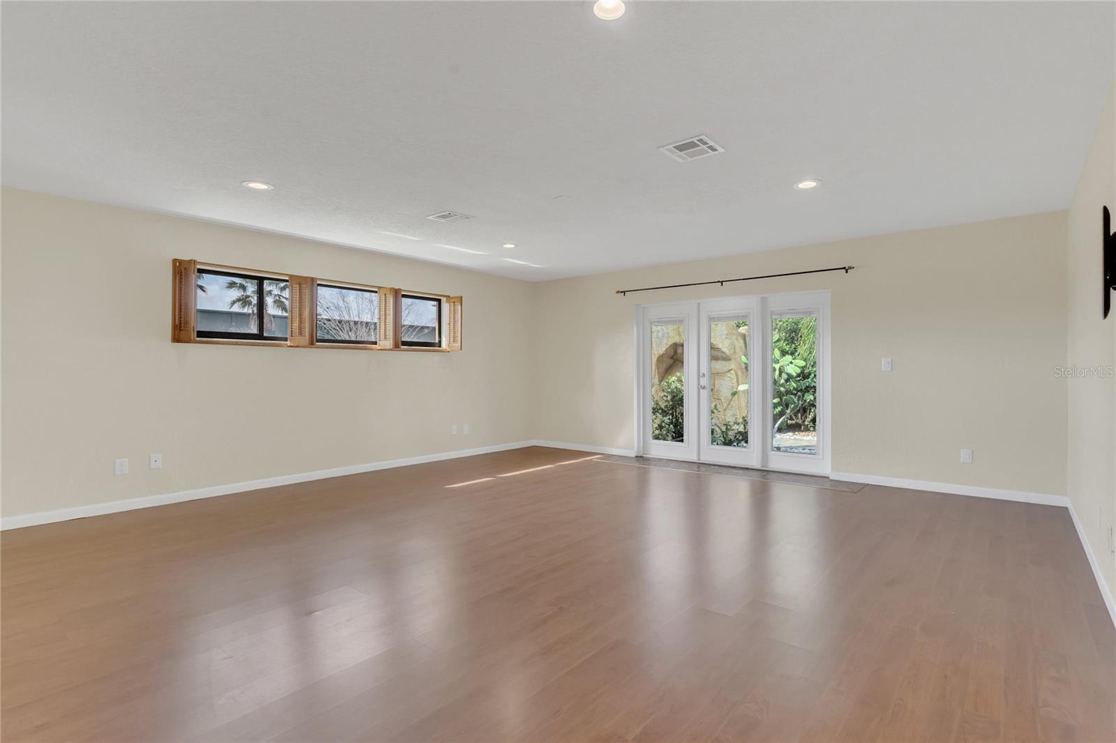 The spacious primary bedroom with doors out to the lanai