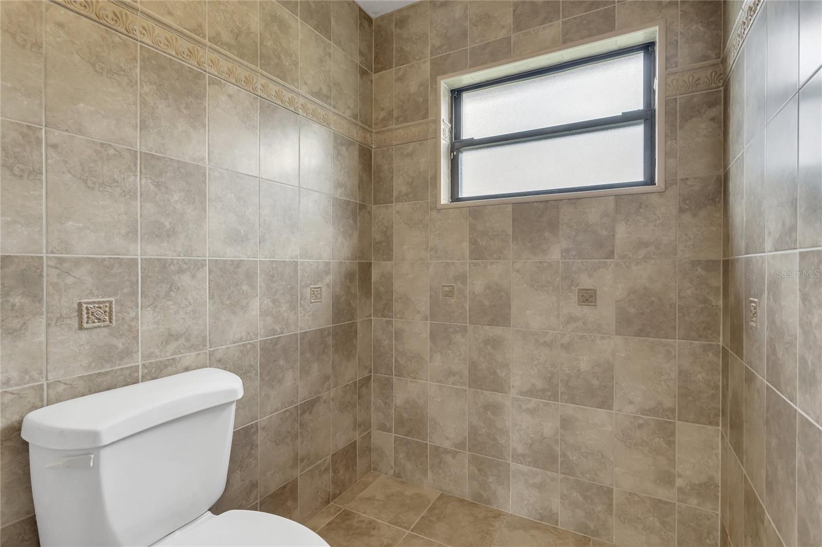 This bathroom used to have a shower - the plumbing is in the wall so it could easily be transformed back into a shower or add a tub in here